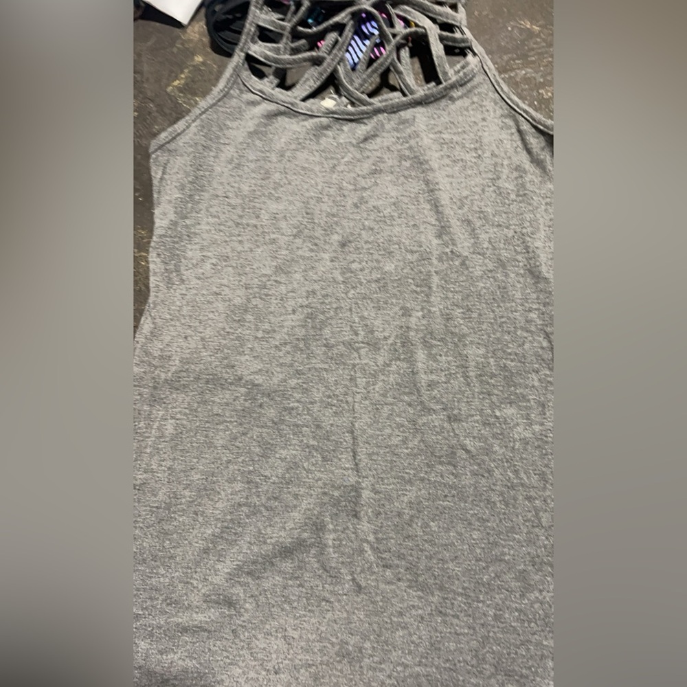 Tank tops with criss cross necks the fist at two are m and the last one is a s